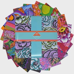 May include: A selection of patterned fabric squares in a circular arrangement. The fabrics display floral and abstract designs in purple, orange, green, and pink hues. A blue band with text is wrapped around the center of the fabric squares.