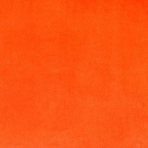 Könnte beinhalten: Ein einfarbiger orangefarbener Hintergrund mit leicht strukturierter Oberfläche.