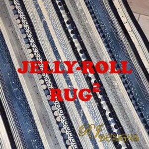 May include: A rectangular rug with a striped pattern in shades of blue, gray, and white. The rug features various designs within the stripes, including dots and geometric shapes. The text "JELLY-ROLL RUG" is displayed in red, along with the word "RUG" and the designer's logo.