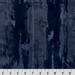 May include: A close-up of a dark blue fabric with a fuzzy texture. The fabric has a subtle, irregular pattern that resembles fur.