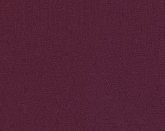 May include: A solid, deep burgundy fabric with a subtle texture. The fabric has a smooth, even surface with a slight sheen.