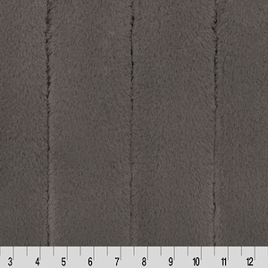 May include: A close-up of a charcoal grey plush fabric with a vertical ribbed texture. The fabric is soft and fuzzy.