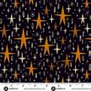 May include: Dark navy fabric with a repeating pattern of gold and white stars and small, elongated shapes. The stars vary in size, with some appearing as five-pointed shapes and others as smaller, more numerous accents. The fabric has a celestial theme.