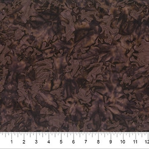May include: Brown batik fabric with a swirling, abstract pattern. The fabric has a subtle sheen and a soft, drapey texture.