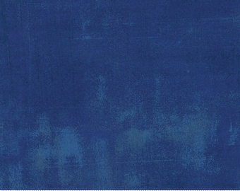 May include: A solid blue fabric with a subtle textured pattern. The fabric is a solid color with a slight variation in the shade of blue. The fabric is shown with a ruler that reads "moda" and "www.modafabrics.com".