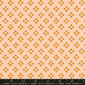 May include: Peach-colored fabric with a repeating pattern of four orange dots arranged in a square. The fabric has a ruler along the bottom edge with the text "RUBY STAR SOCIETY".
