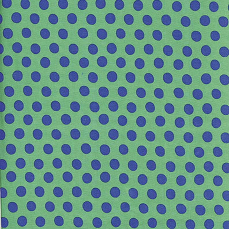 May include: A green fabric with a repeating pattern of blue polka dots.