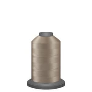 May include: A spool of beige thread for sewing or embroidery.