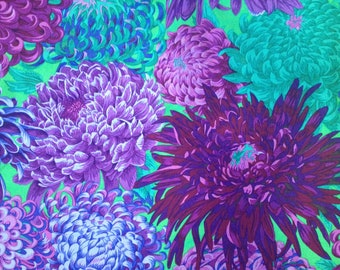 May include: A vibrant floral fabric featuring a close-up of purple, blue, and green chrysanthemums. The fabric has a green background and the flowers are arranged in a random pattern.
