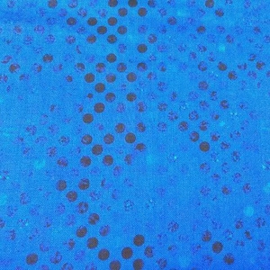 May include: A bright blue fabric featuring a repeating pattern of dark navy blue dots arranged in a diagonal, gradient-like formation. The surface has a subtle, woven texture with varying shades of blue creating a depth effect across the material.