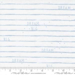 May include: White fabric with light blue stripes and the words "Dream Big" repeated throughout.