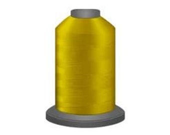 May include: A spool of bright yellow thread.