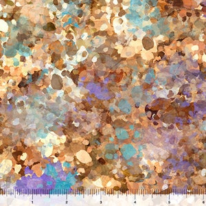 May include: Abstract watercolor fabric with a speckled pattern. The design features a mix of colors, including brown, beige, blue, and purple. The fabric has a ruler along the bottom edge, with markings in inches.