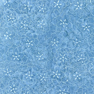 May include: A close-up of a light blue fabric with a repeating floral pattern. The design features white, five-petal flowers surrounded by small white dots. The fabric has a textured appearance.