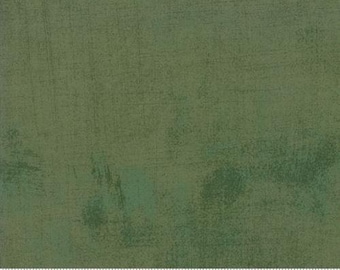 May include: A green fabric with a textured, distressed look. The fabric has a subtle blue hue throughout. The fabric is measured in inches.