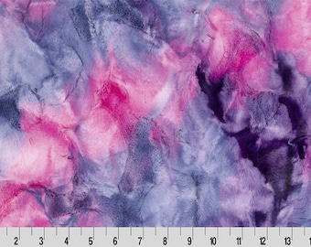 May include: A plush fabric with a swirling pattern in shades of pink, purple, and blue. The fabric has a soft, textured appearance, with a ruler along the bottom edge showing measurements in inches.