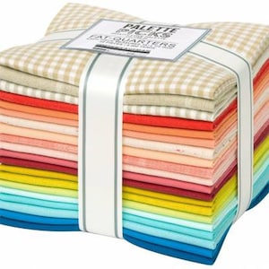 May include: A stack of 24 fat quarter fabric bundles in various colors, including blue, green, yellow, orange, red, and pink. The fabric is wrapped in white ribbon and a label that reads "Palette Picks Fat Quarters".