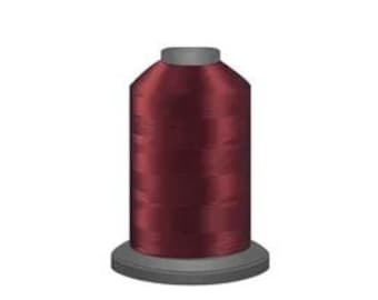 May include: A spool of maroon embroidery thread.