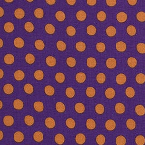 May include: Purple fabric with a repeating pattern of orange polka dots.