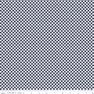 May include: A fabric with a navy blue and white checkerboard pattern. The pattern is made up of small, evenly spaced squares. The fabric has a ruler at the bottom with the text "Inches" and "Riley Blake Designs".