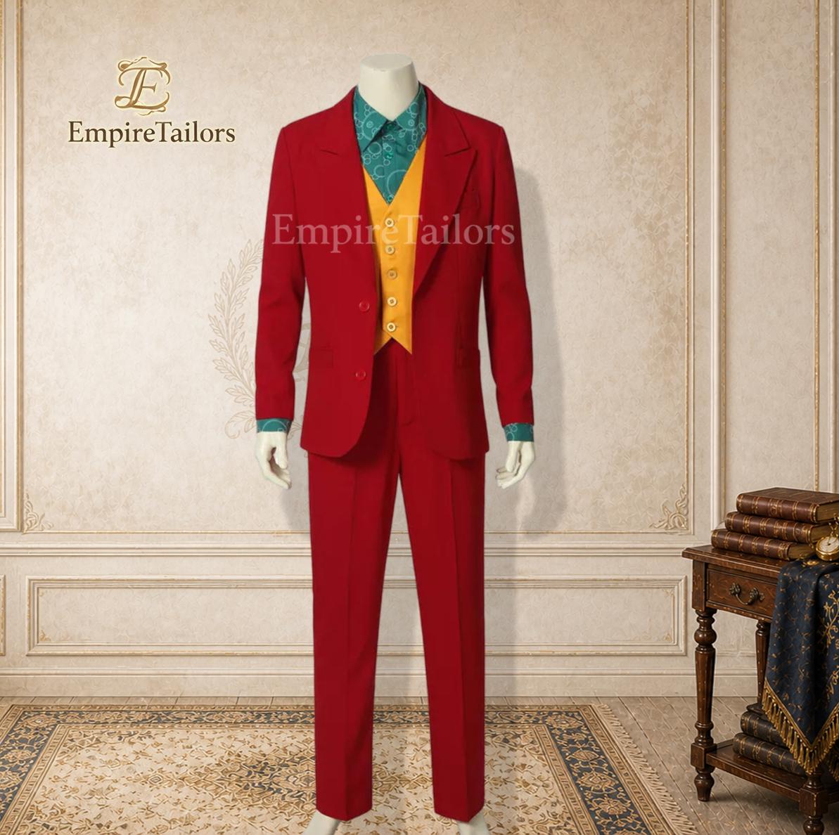 May include: A three-piece suit comprising a vibrant red blazer and matching trousers, a mustard yellow waistcoat with five buttons, and a teal patterned button-down shirt. The Empire Tailors logo is visible in the upper left corner of the image.