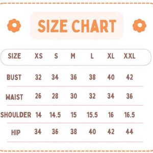 May include: A size chart with the title "SIZE CHART" in a white box with an orange border. The chart lists sizes XS to XXL, with bust measurements from 32 to 42 inches, waist measurements from 26 to 36 inches, shoulder measurements from 14 to 16.5 inches, and hip measurements from 34 to 44 inches.
