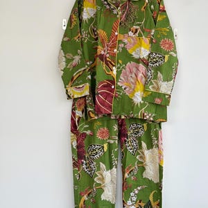 May include: A white ceramic mug with a black handle and the text "But First, Coffee" in a black, bold font. The mug is sitting on a white surface. The mug is approximately 4 inches tall.