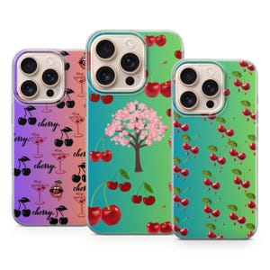 May include: Three phone cases with cherry designs. One case has a gradient purple background with cherries and cocktail glasses. Another has a green and blue gradient with a cherry blossom tree. The third case has a green and blue gradient with cherry branches.