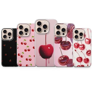 May include: Five phone cases with cherry designs. The cases feature various patterns, including a black case with small red cherries, a pink case with cherry branches, and a case with a single large cherry with dripping juice.