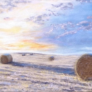 May include: A pastel painting of a harvested field with several cylindrical hay bales scattered across the landscape under a bright sky with soft clouds in shades of blue, white, and yellow, capturing the warm light of a setting sun.