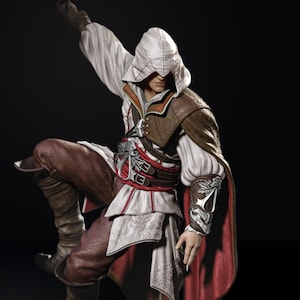 May include: A detailed figurine of a character in a white hooded tunic, brown leather armor, and red accents. The figure is in a dynamic pose, with one leg bent and an arm raised, suggesting action. The figure is from the Assassin's Creed video game series.