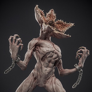May include: A detailed sculpture of a Demogorgon from the Stranger Things series. The creature is depicted with a textured, fleshy body, sharp claws, and a multi-petaled head. It is bound by chains on its wrists.