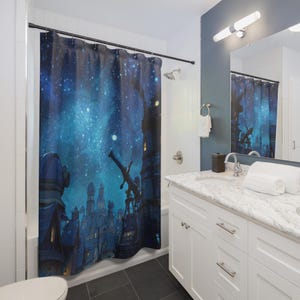 May include: A blue shower curtain featuring a nighttime cityscape under a starry sky. The design includes buildings, a telescope, and a deep blue and teal color palette. The curtain adds a unique, artistic touch to a bathroom.