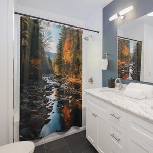 May include: A shower curtain featuring a scenic river flowing through a forest in autumn. The curtain displays a vibrant landscape with trees in shades of green, orange, and brown, and a rocky riverbed. The design evokes a sense of nature and tranquility.