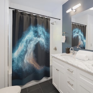 May include: A dark shower curtain with a vibrant, abstract design. The artwork features swirling blue and white cloud-like formations against a black background, with hints of orange. The curtain is hanging in a bathroom setting.