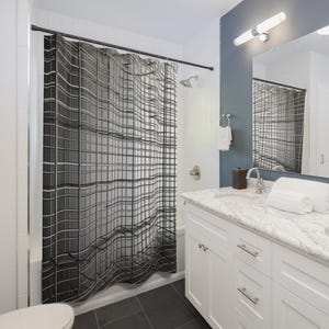 May include: A black and white shower curtain with a grid pattern hangs in a modern bathroom. The curtain is the focal point, with a wavy, geometric design. The bathroom features a white vanity, a mirror, and a dark gray floor.