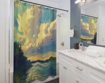 May include: A shower curtain with an impressionistic landscape painting. The artwork shows a vibrant sky with large, fluffy yellow and white clouds above a body of water and a dark green treeline. The curtain hangs in a modern bathroom.