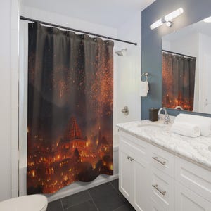 May include: A dark shower curtain featuring a vibrant, fiery cityscape design. The artwork depicts a city with illuminated buildings and a dramatic sky filled with bursts of orange and red. The curtain is hanging in a bathroom setting.