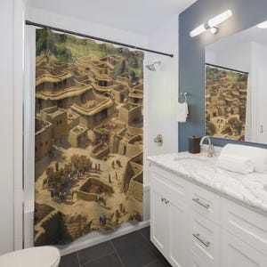 May include: Shower curtain featuring a detailed illustration of an ancient village with tan buildings and thatched roofs. The artwork depicts people and animals in a desert landscape, creating a historical or travel theme. The curtain is hung in a modern bathroom setting.
