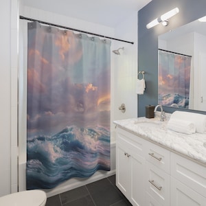 May include: Shower curtain with a seascape design, depicting ocean waves under a cloudy sky. The curtain's colours include blues, purples, and oranges, offering a tranquil and artistic touch to a bathroom.