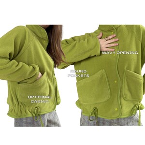 K&ouml;nnte beinhalten: Hellgr&uuml;ne Fleecejacke mit runden Taschen, einem wellenf&ouml;rmigen Ausschnitt und einem optionalen Bund am Bund. Die Jacke hat eine Knopfleiste vorne und lange &Auml;rmel. Die Jacke ist aus einem weichen, strukturierten Material gefertigt.