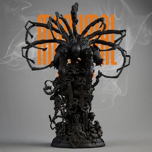 May include: A black sculpture with a detailed, multi-layered design, featuring a central figure and intricate, spidery appendages. The sculpture includes the word "MANUAL" in orange block letters. The base features skulls and cross imagery.