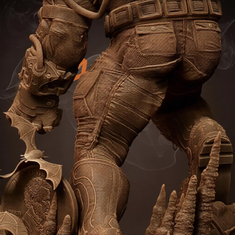 May include: A detailed brown statue of a figure in a textured suit with a utility belt and pockets. The statue has a bat-shaped emblem and a memorial with the text "In God We Trust" and a portrait.