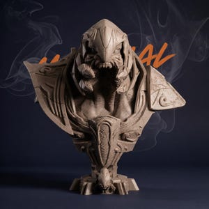 May include: A detailed bust sculpture of a creature with a menacing expression. The sculpture is a neutral beige color, with intricate details on the head, shoulders, and chest. The word "AL" is visible in orange on the right side of the image.