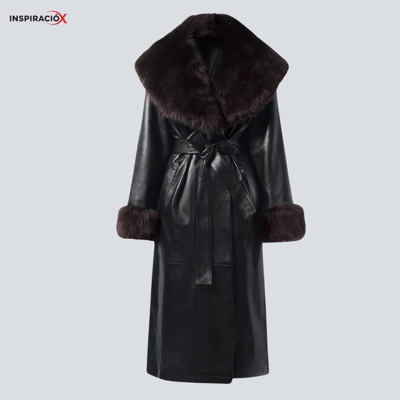 May include: A long black leather coat with a wide, dark brown fur collar and matching fur cuffs. The coat features a belted waist and a classic, elegant design. The coat is a stylish outerwear piece.