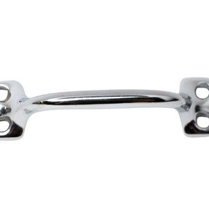 May include: A chrome-plated metal handle with two holes on each side. The handle is curved and has a smooth finish.