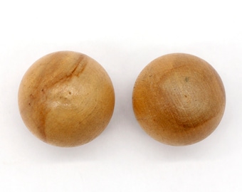May include: Two smooth, light brown wooden balls. The balls have a natural wood grain pattern.