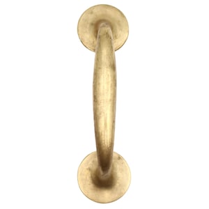May include: A vintage-style brass door pull handle. The handle has a curved, cylindrical grip and is attached to two circular mounting plates. The brass has a warm, aged patina, suggesting it is an antique or a reproduction.