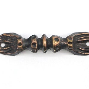 May include: A decorative metal handle with a stylized design. The handle is a dark bronze color with gold accents.