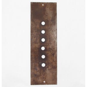 May include: A rectangular, weathered metal plate with six evenly spaced circular holes and two smaller holes at the top and bottom. The plate has a rusty brown colour and appears aged.